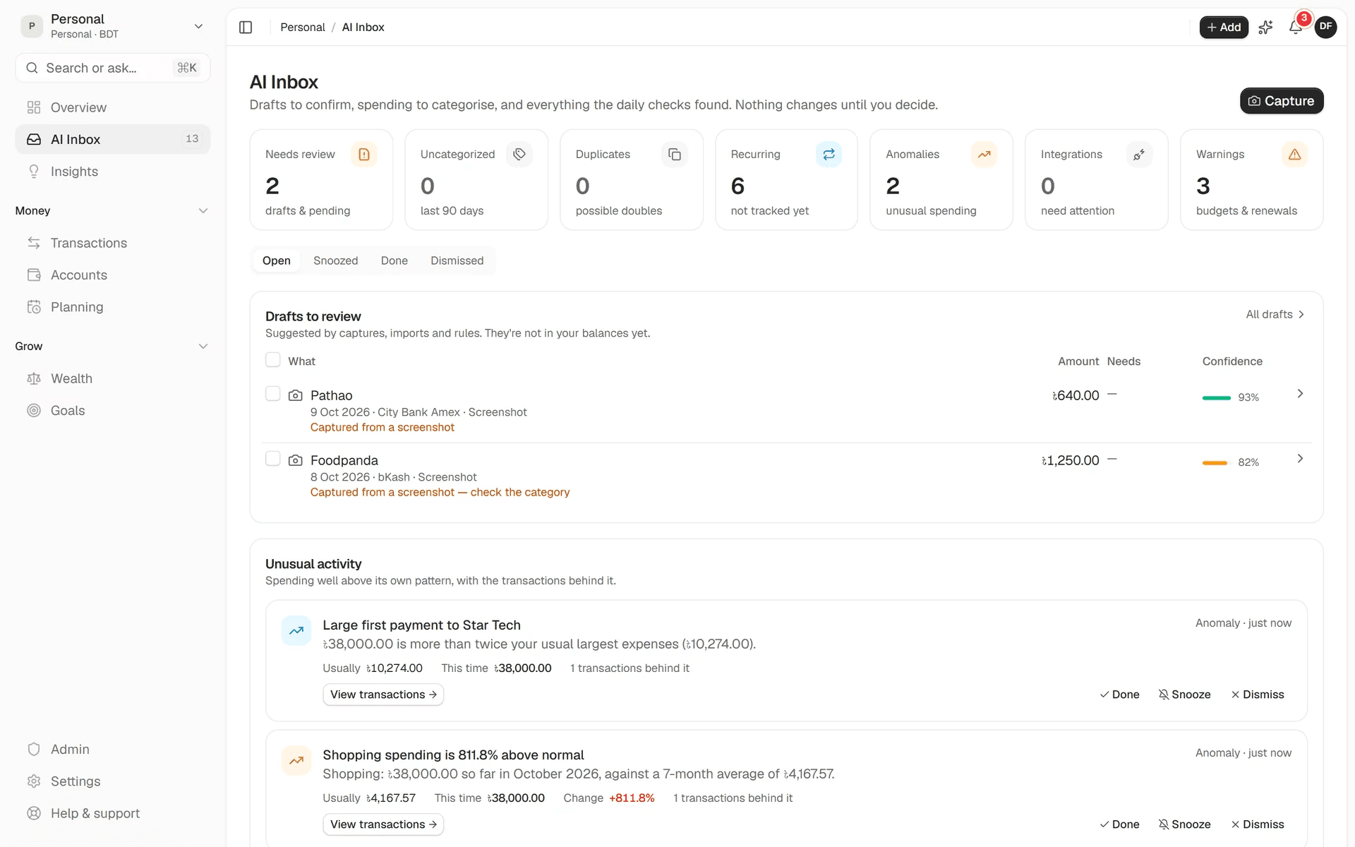 AI Inbox with two receipt drafts to review, each with a confidence score, and unusual spending flagged with the transactions behind it